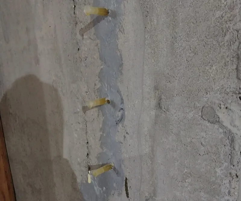 Structural crack stitching in the foundation wall in Mt Sinai home.
