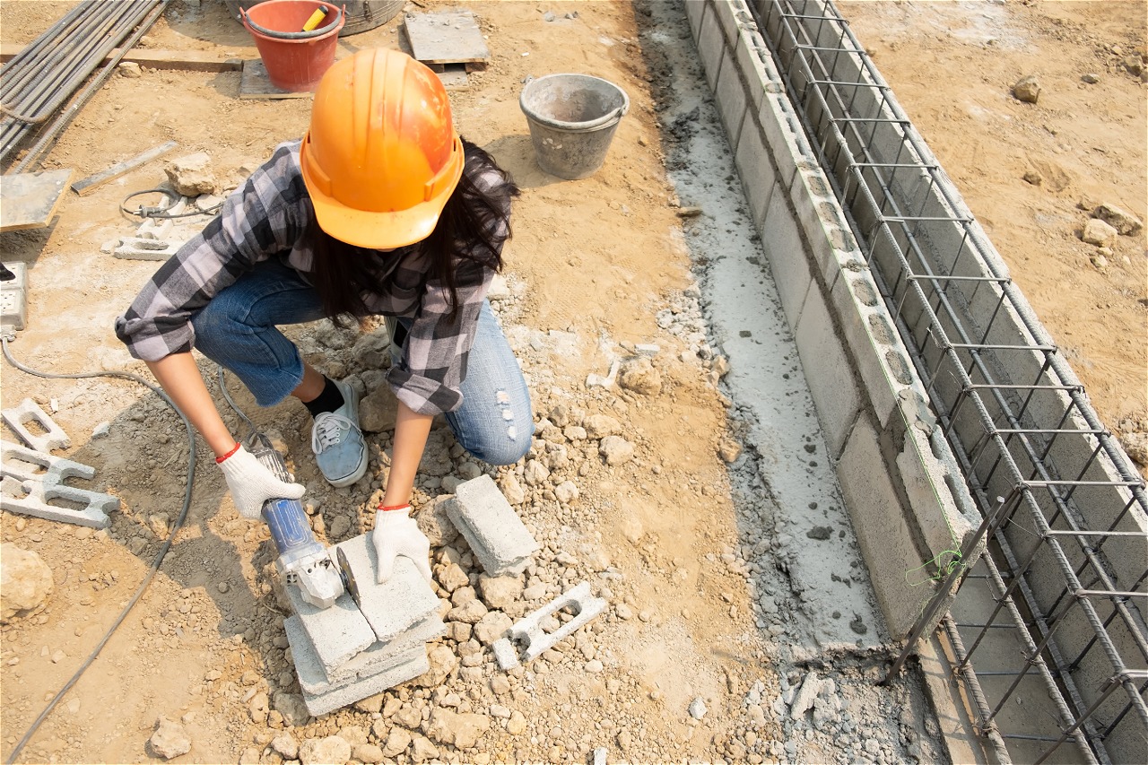 A contractor laying out the footing in the foundation