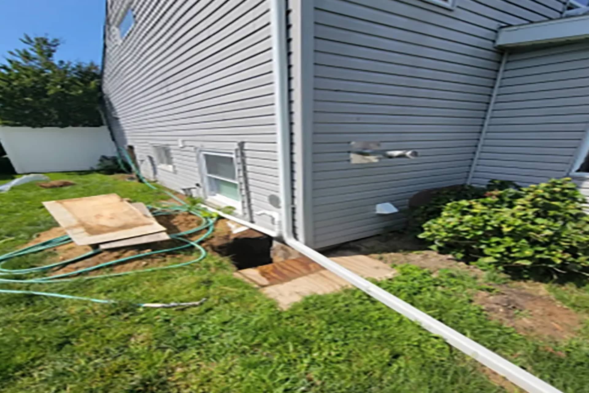 Below-Grade Waterproofing - A House with the Soil in Front of the Home Excavated, Showing the Foundation Footing