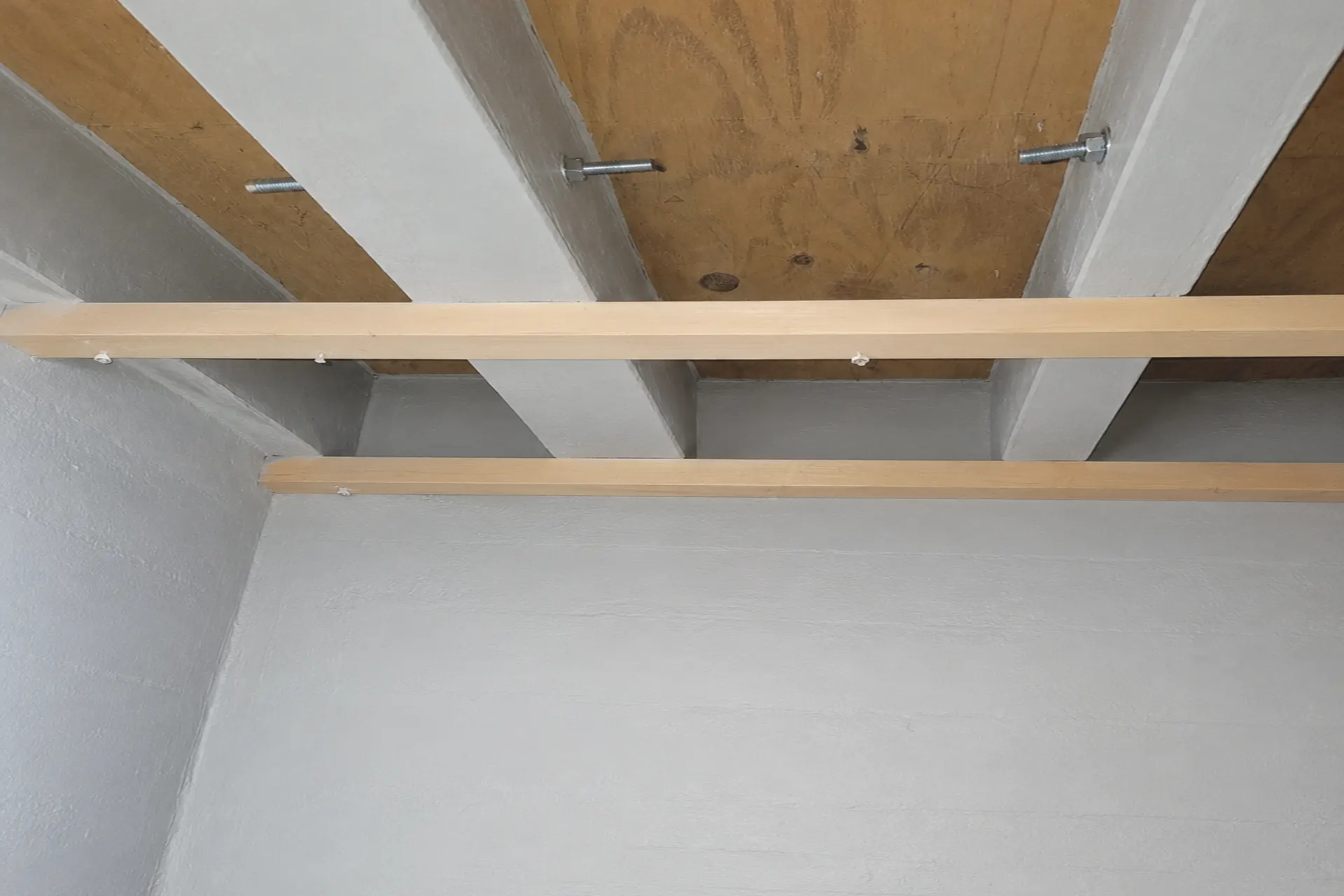 completed-basement-waterproofing-featured Finished basement waterproofing project in Brooklyn NY with reinforced concrete slab, French drain system, waterproofed foundation walls, and insulated rim joists