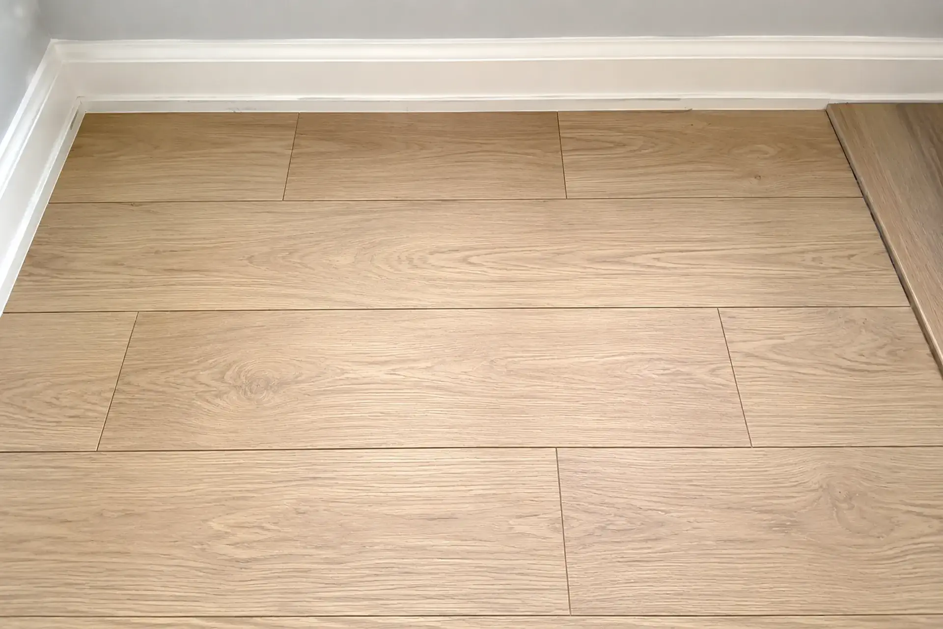 completed-bedroom-floor-waterproofing-featured Completed bedroom floor waterproofing and subfloor repair project in Brooklyn NY featuring reinforced vapor barrier installation, floating floor system, restored subfloor structure, and finished flooring.
