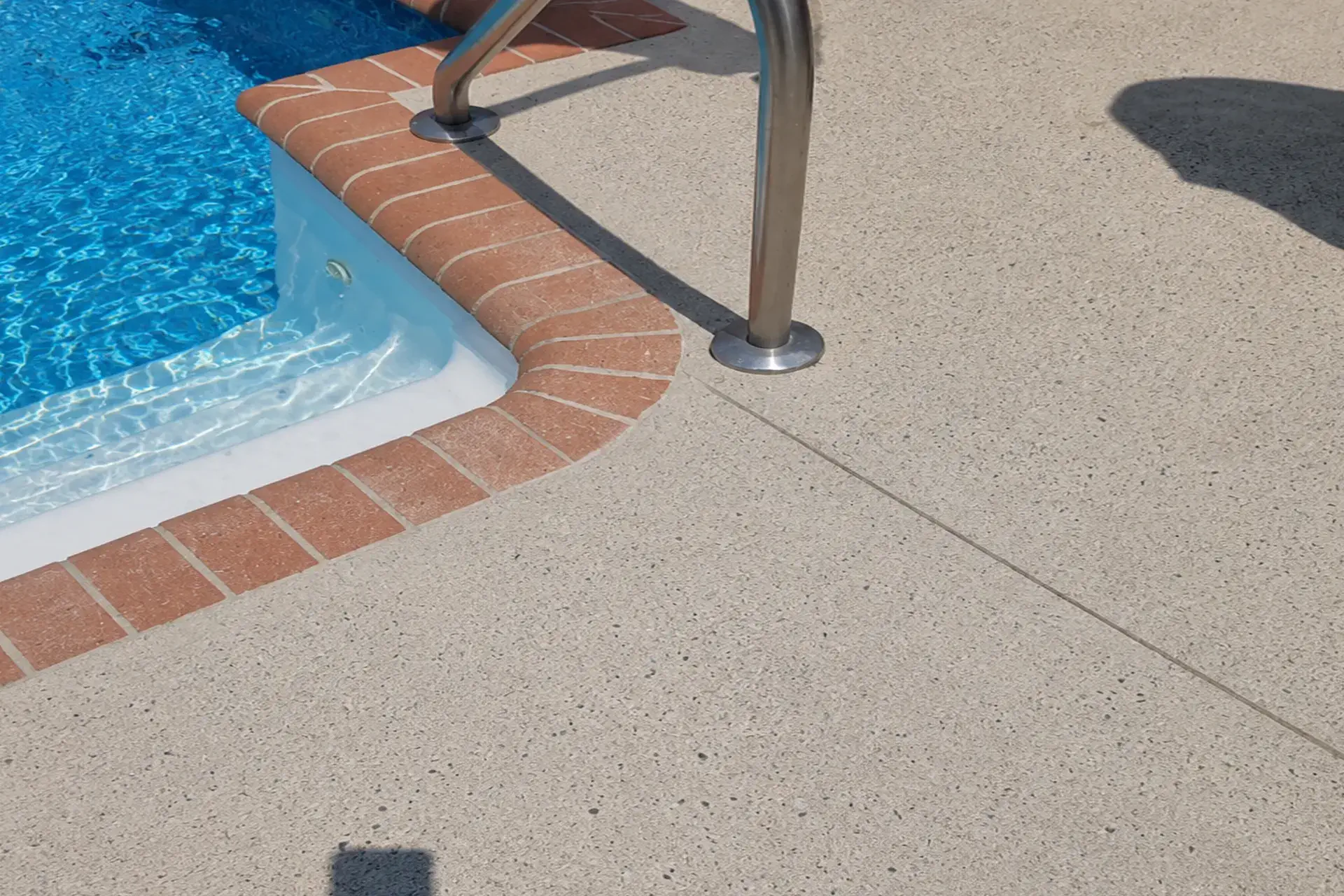 completed-mudjacking-and-concrete-leveling-featured Pool deck concrete leveling project in Glen Cove NY with mudjacking, slab stabilization, and restored drainage around a residential swimming pool.