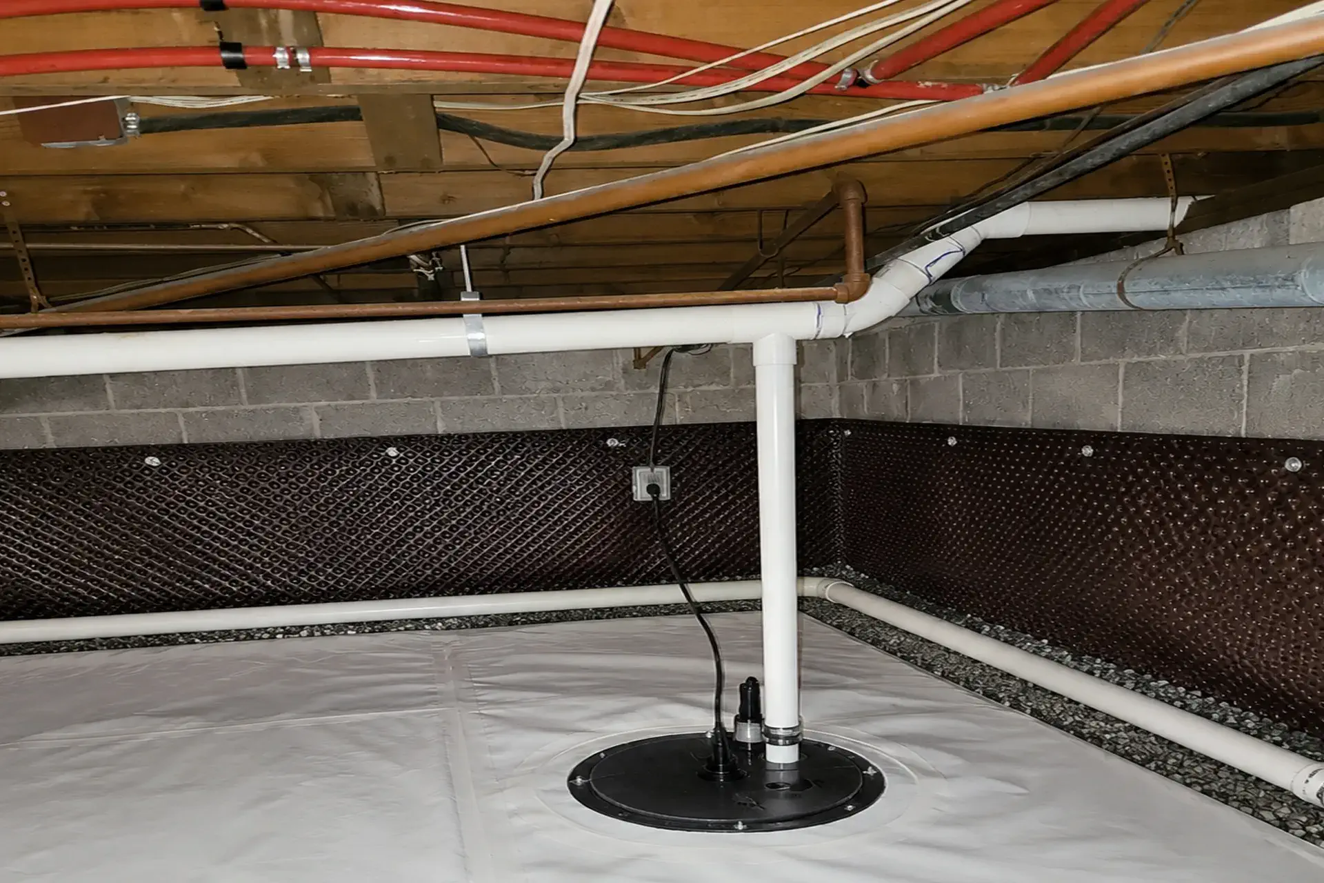crawl-space-featured Completed crawl space waterproofing system in Bayport NY featuring French drain installation, sump pump basin, waterproofing membrane, and foundation drainage improvements.