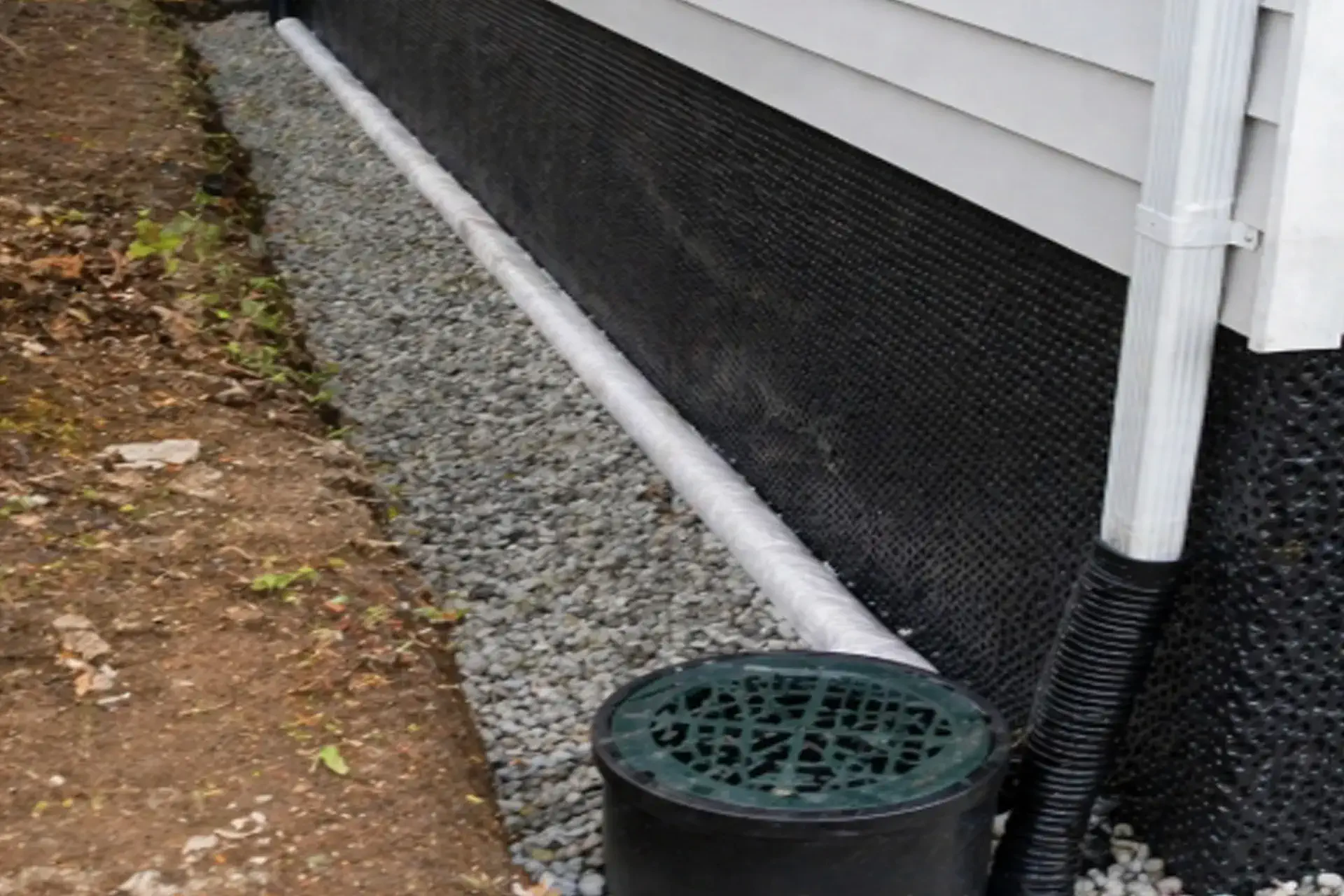 foundation waterproofing Hollis NY exterior drainage membrane installed perforated pipe dry well system protecting home from water buildup