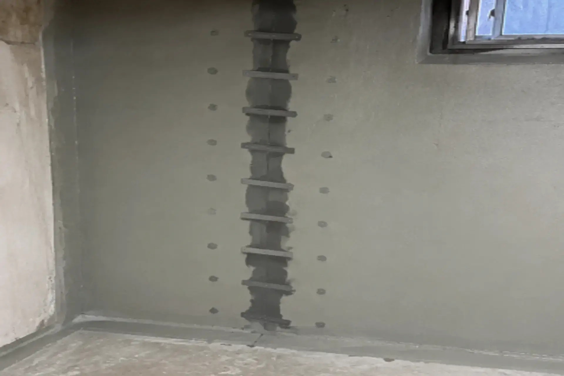finished-structural-foundation-crack-repair-featured Completed structural foundation crack repair in Maspeth NY using carbon fiber stitches, epoxy injection, and waterproof coating.