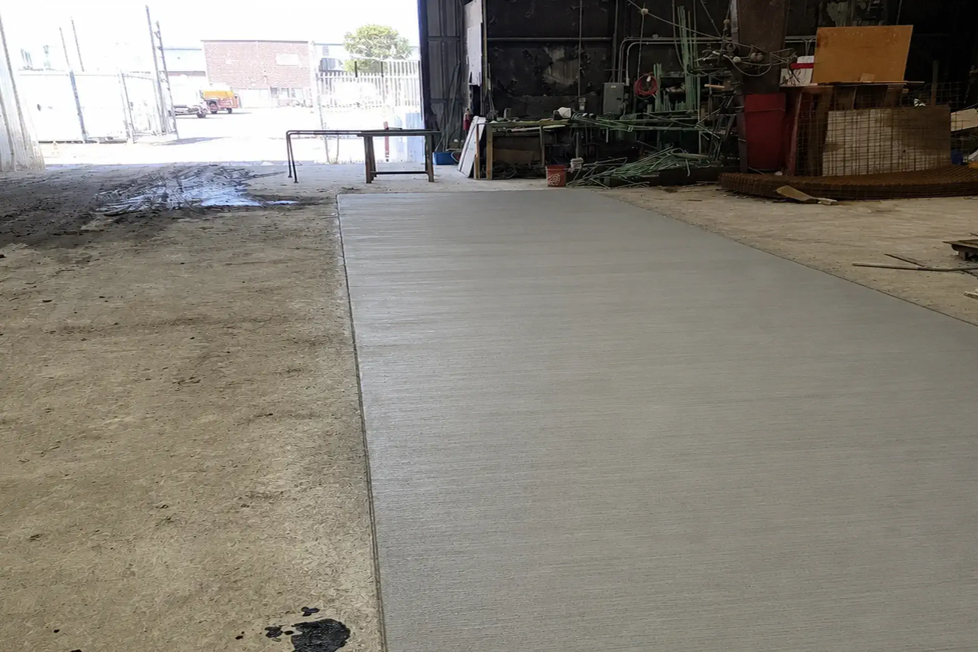 level-reinforced-concrete-overlay-installed-featured Completed elevated concrete overlay installation in Bay Shore NY showing a level reinforced concrete surface over an existing slab.