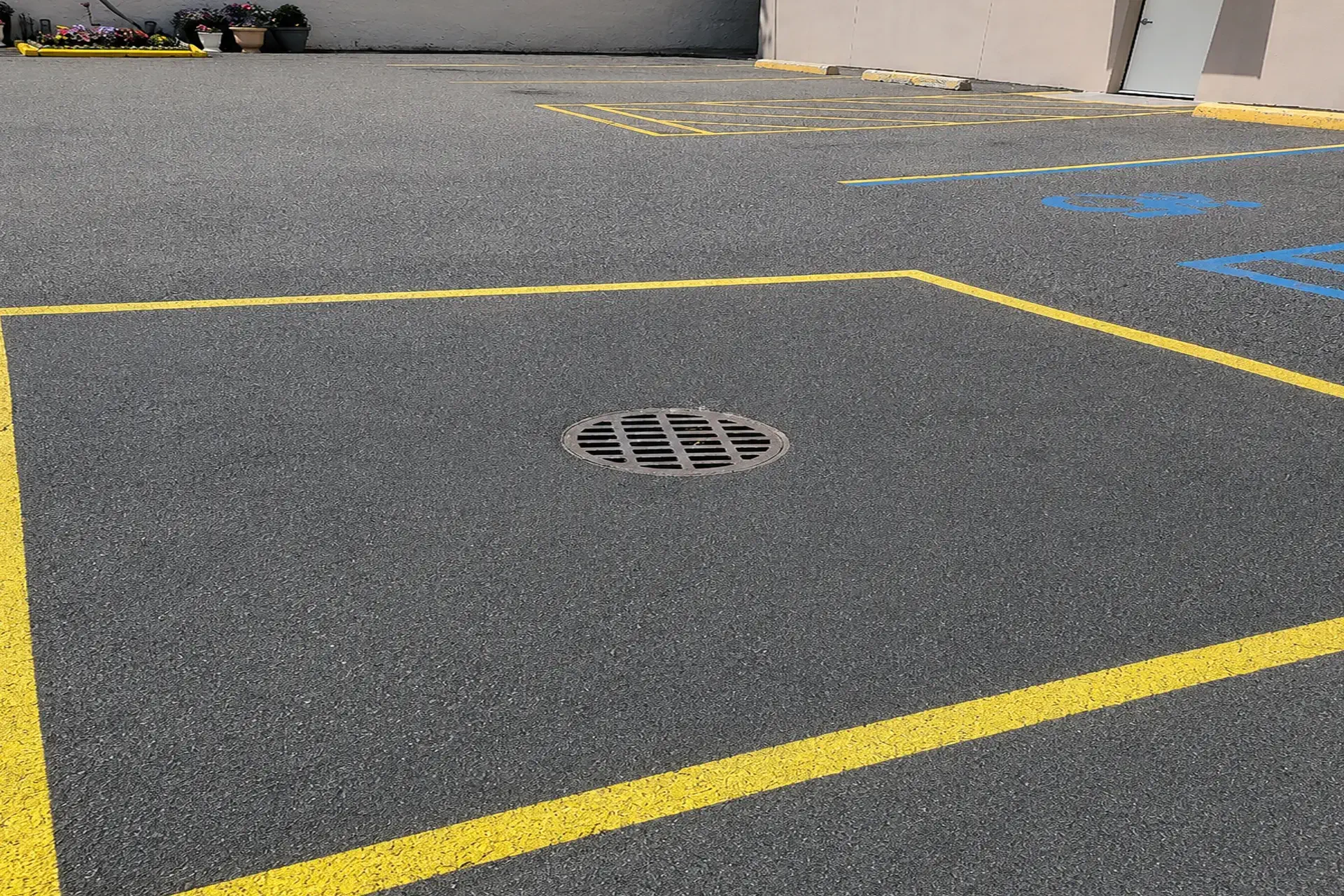 new-asphalt-surface-installed-featured Completed sinkhole repair and asphalt restoration in Woodside NY showing stabilized ground and newly installed asphalt surface.