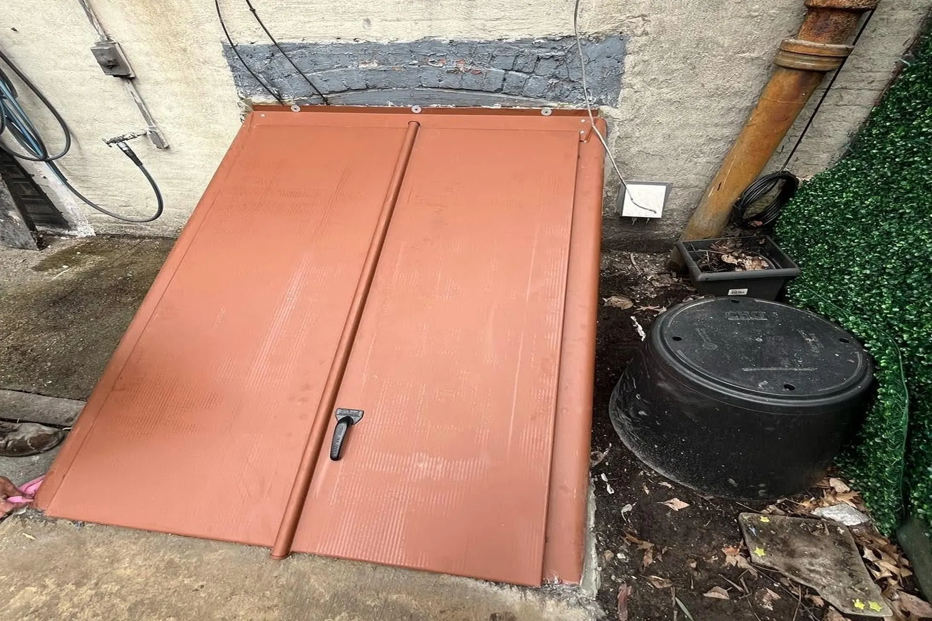 new-bilco-door-installation-featured Completed Bilco door replacement and laundry room restoration project in Brooklyn NY featuring new basement entrance, foundation extension, rebuilt laundry platform, and epoxy-coated floor.