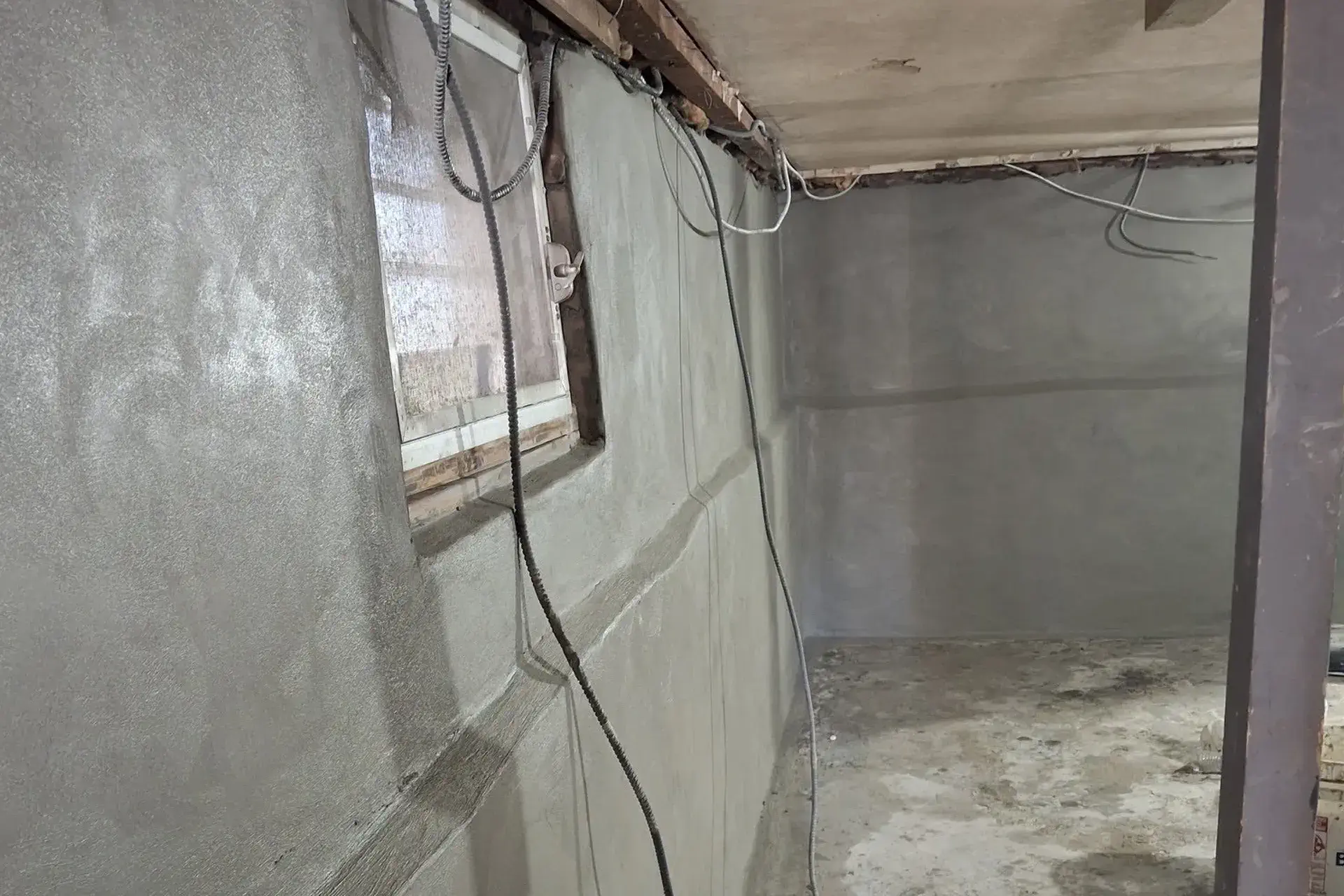 repaired-foundation-wall-featured Repaired and waterproofed foundation wall in Flushing NY with restored masonry, replaced cinder blocks, and waterproofing cement application.