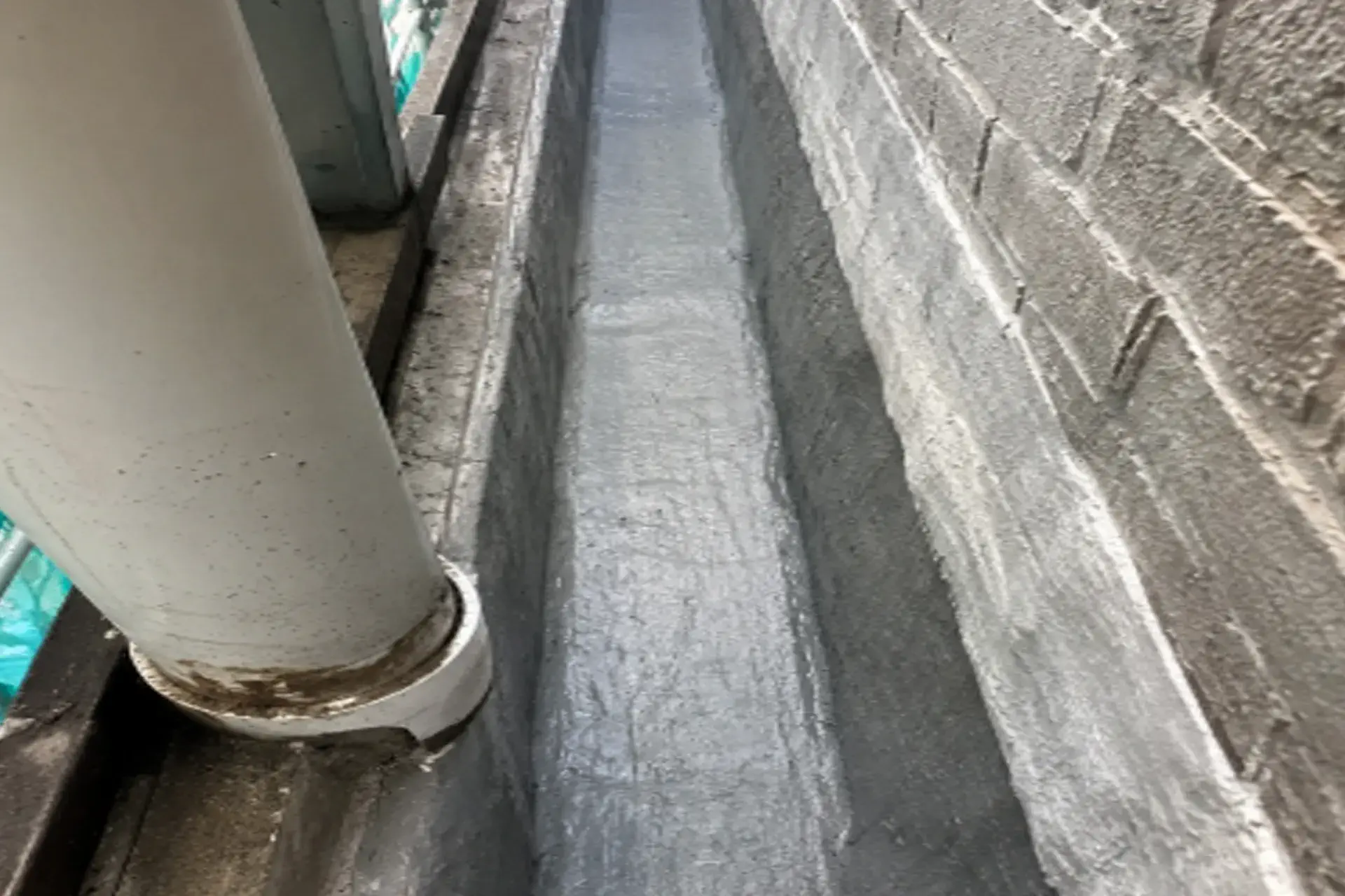 showing-completed-waterproof-channel-system-featured Waterproofing repair project in Brooklyn, NY showing completed waterproof channel system, sealed wall cavity, and moisture control improvements.