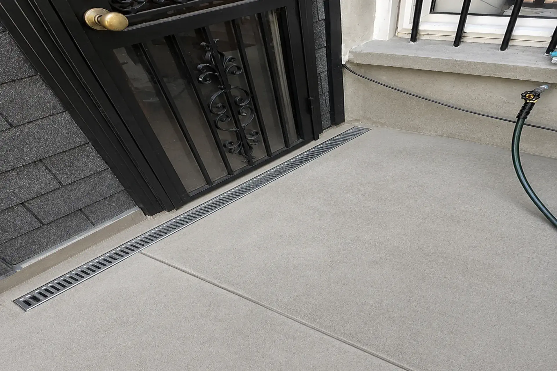 stormwater-drainage-system-installation-featured Stormwater drainage system installation in Brooklyn NY with trench drains, sump pump, and drywells designed to prevent water intrusion.