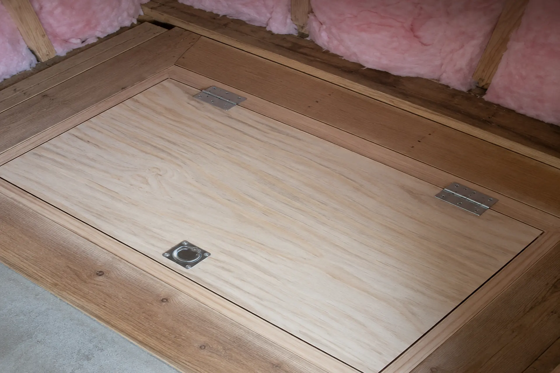 completed-crawl-space-featured Custom plywood crawl space access door installed in a Sayville, NY home with durable hinges and secure hardware.