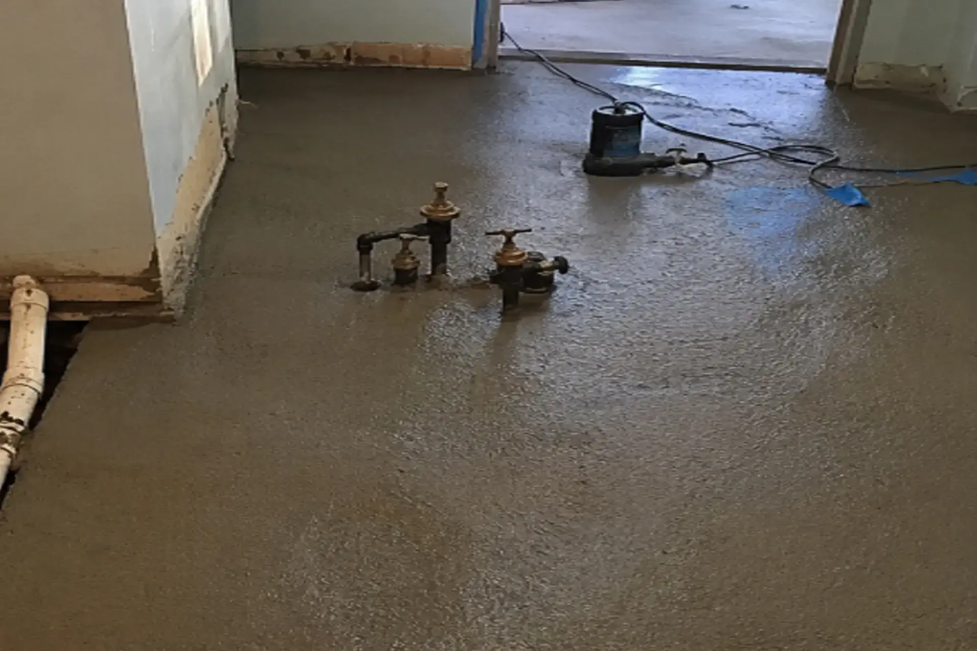 completed-exploratory-work-featured Technician performing exploratory concrete removal during a flooding investigation in a Brooklyn, NY basement.