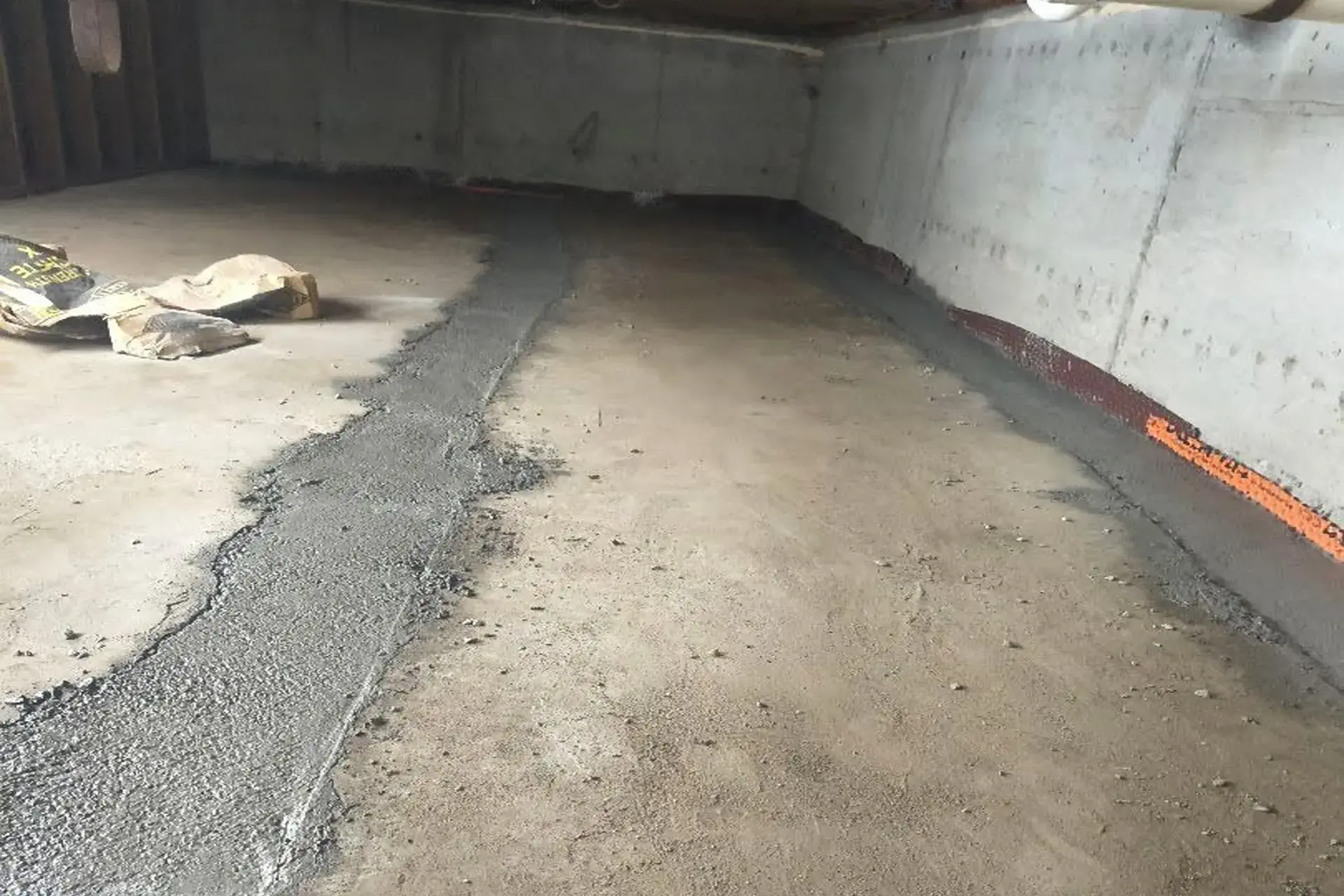 crawl-space-waterproofing-system-with-interior-french-drain-dual-sump-pumps-vapor-barrier Completed crawl space waterproofing system with interior French drain, dual sump pumps, vapor barrier, and restored concrete floor in Far Rockaway, NY.