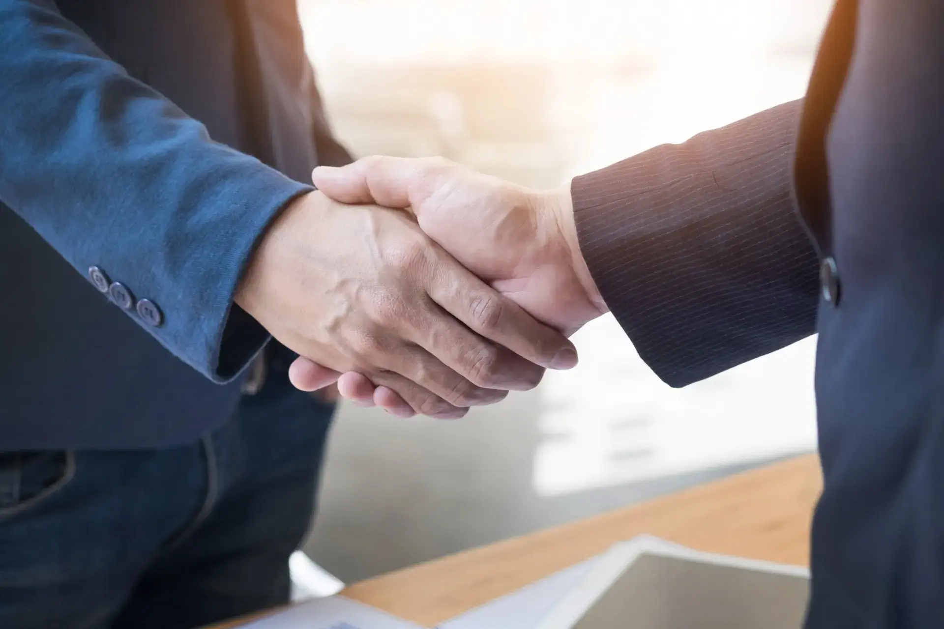 handshake-between-a-smart-realtor-and-a-contractor A handshake between a smart realtor and a contractor over a successful flipping project in Brooklyn, NY