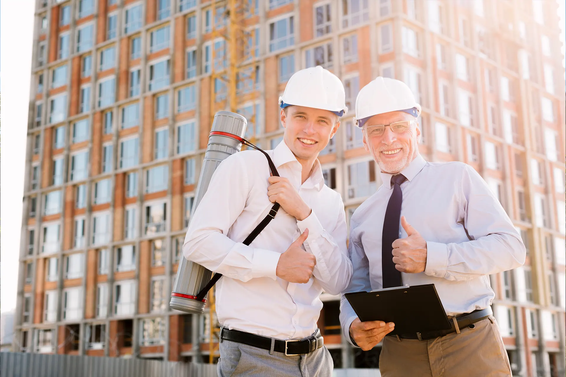 Professional Zavza Seal EIFS insulation contractors in hard hands and one holding a clipboard giving a thumbs up. 