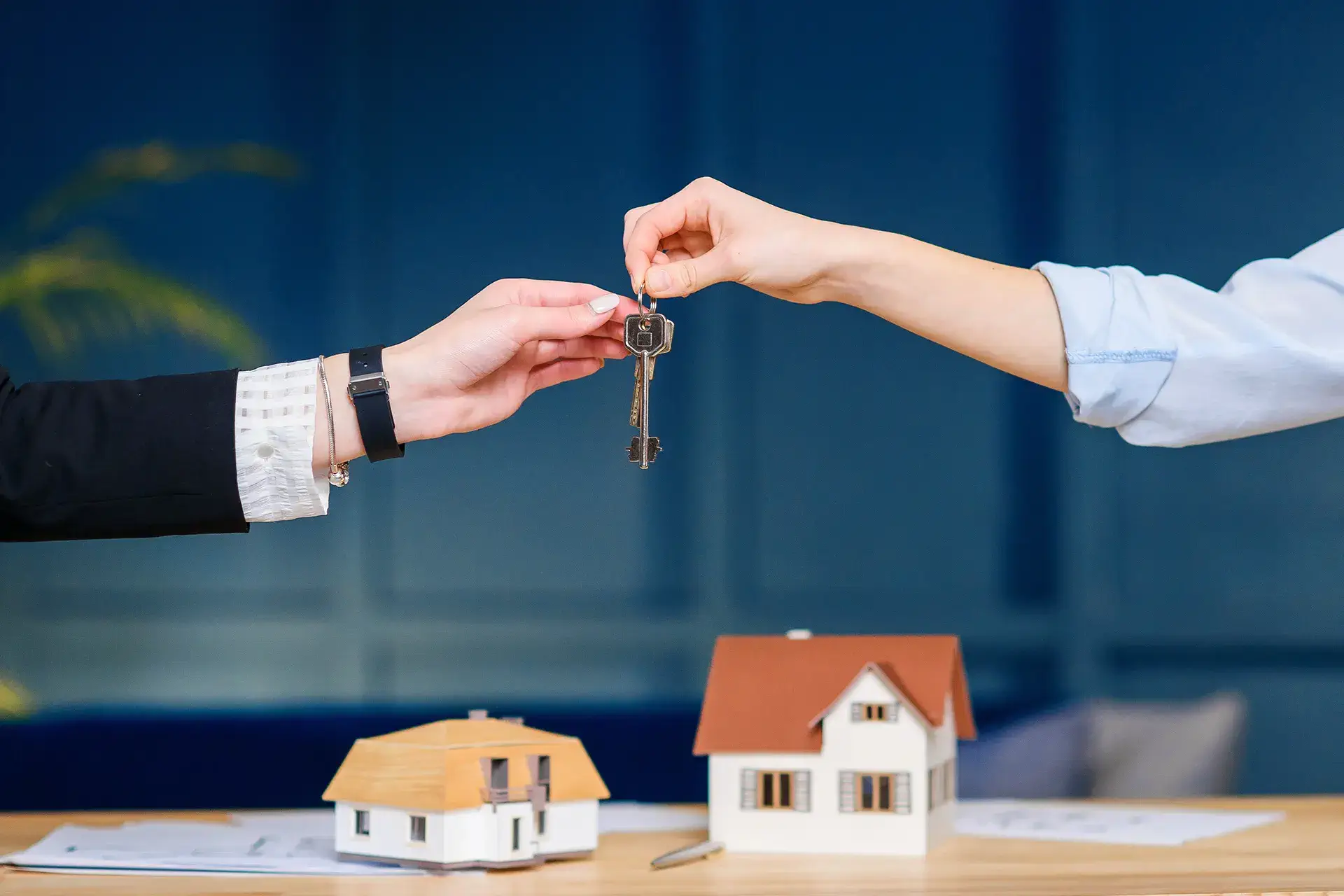 realtor-handing-the-keys-over-to-a-property A realtor handing the keys over to a property that underwent complete basement waterproofing to a new buyer