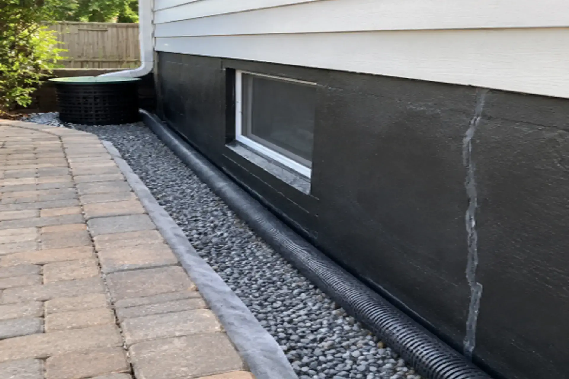 holbrook-ny-foundation-waterproofing-drainage-repair-featured Exterior foundation waterproofing and drainage system at a residential home in Holbrook NY