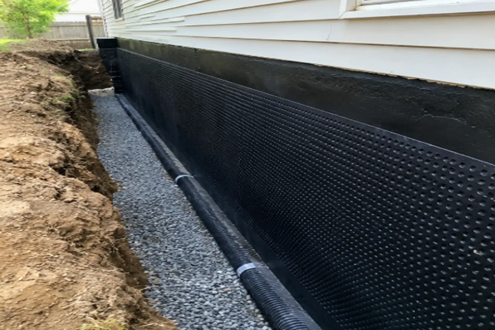 selden-ny-basement-foundation-waterproofing-featured Exterior basement foundation waterproofing in Selden NY with drainage system