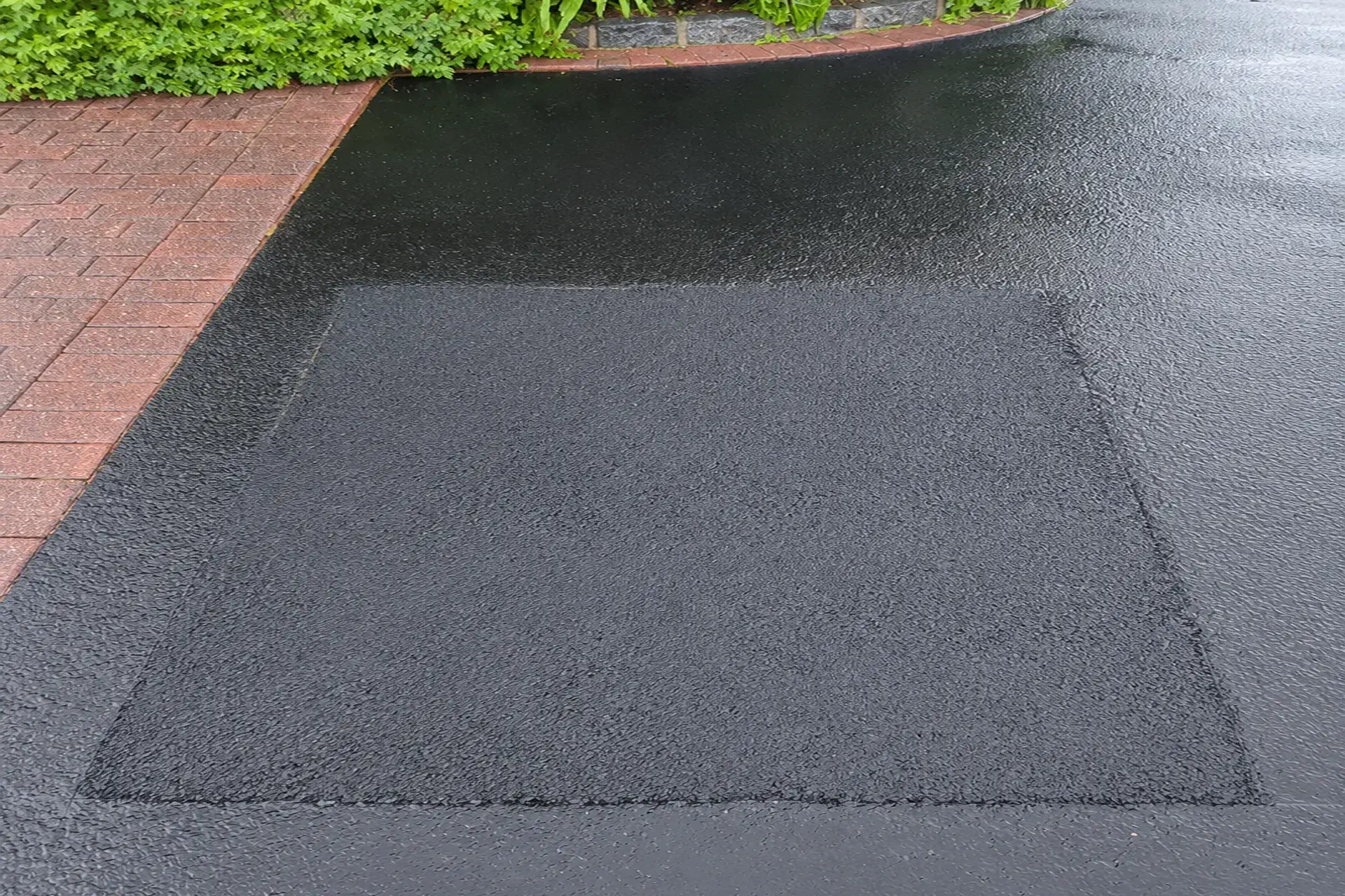 sinkhole-repair-massapequa-ny-after Sinkhole repair with restored asphalt surface in Massapequa NY.